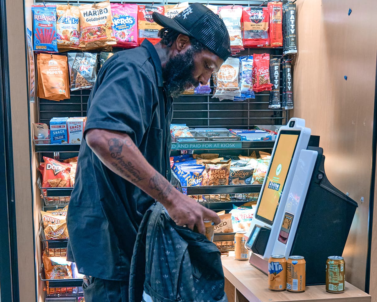 Customer using a micro-market kiosk to purchase items.