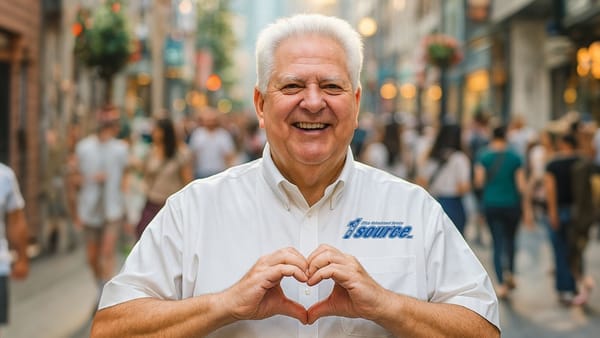 Bob Betz makes heart shape with hands.